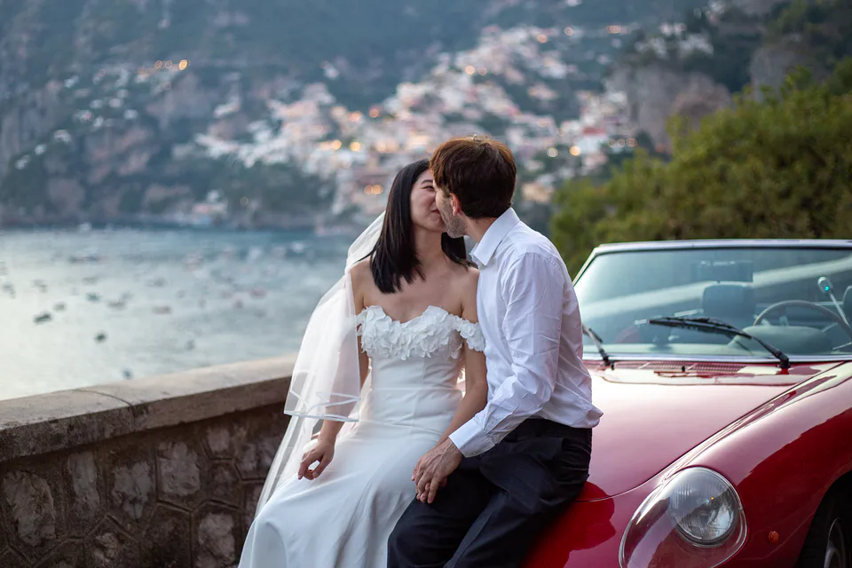 Couple portrait with classic car and Amalfi view