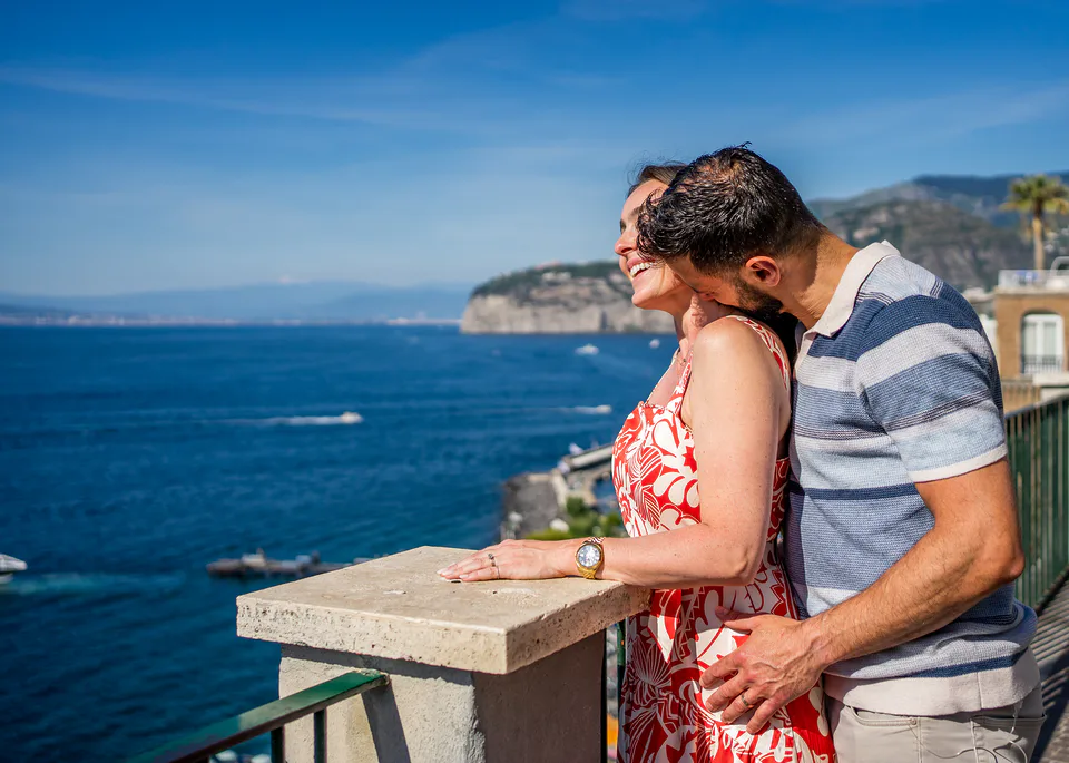 Couple close-up with the coastline behind