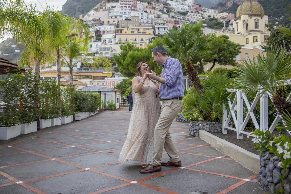 Couple walking among palms in Positano